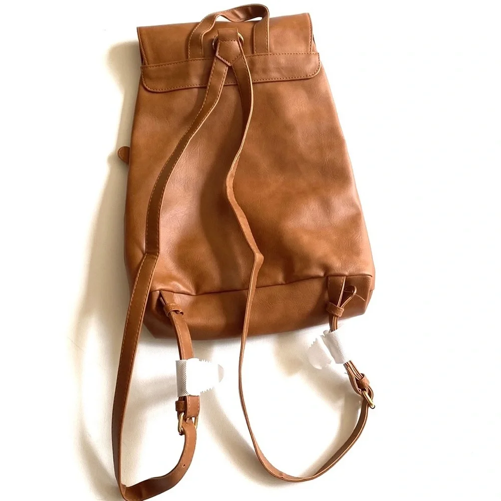 Brown backpack with zipper‎ accented detailing on front, NWOT
